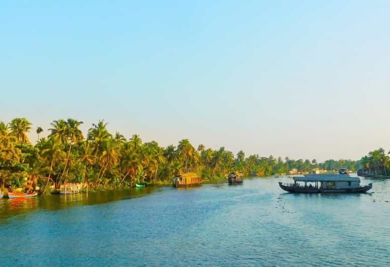 Scenic Kerala backwaters with a boat and lush coconut trees