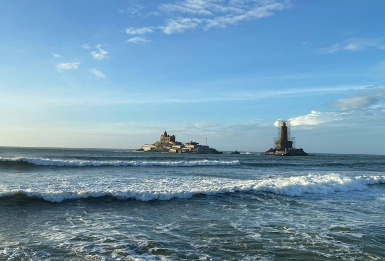 Kerala coastline with a lighthouse and waves along the shore
